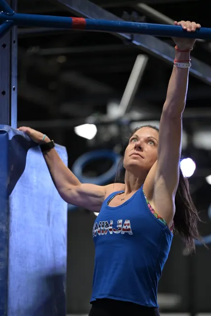 Ashley Kiser reaching up for a bar