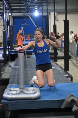 Ashley Kiser landing on a platform with her arms out