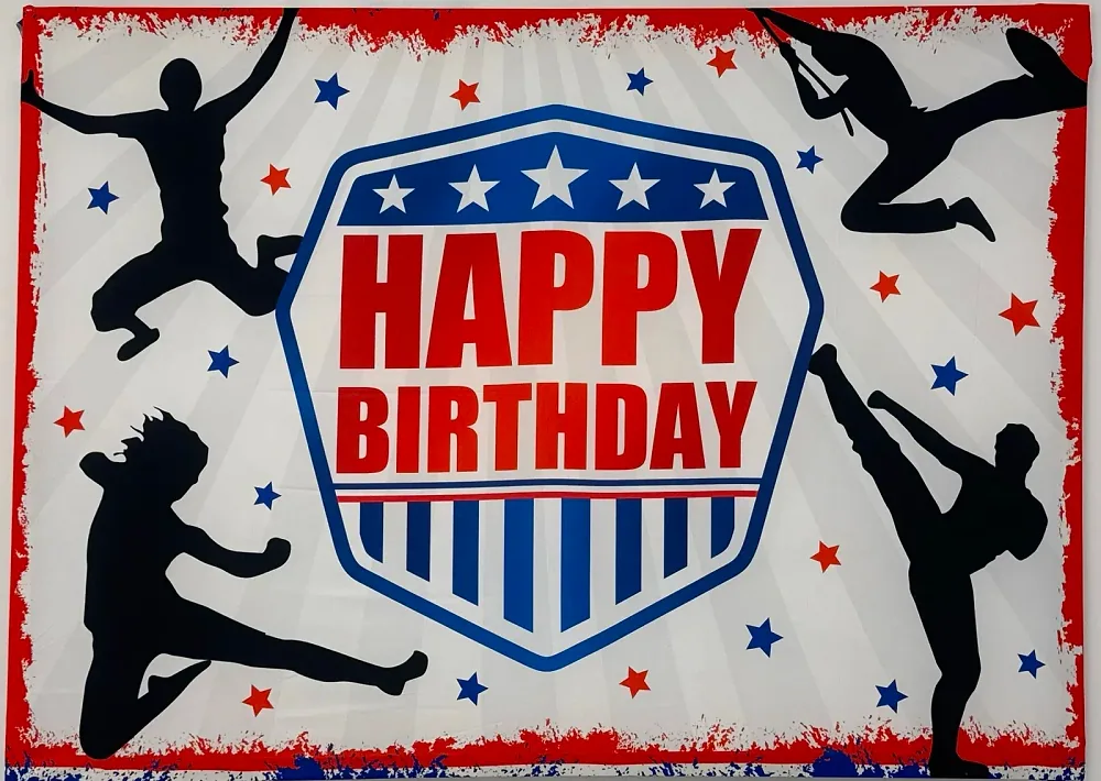 A red, white and blue Happy Birthday banner with silhouettes of ninjas jumping and swinging