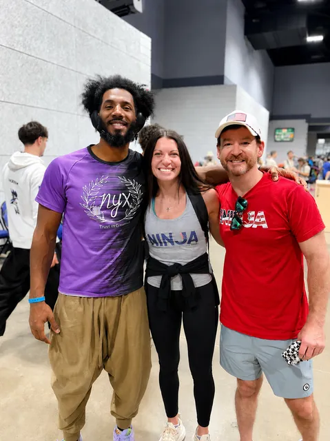 Coach MJ in a purple NYX shirt with Ashley Kiser and David Kiser