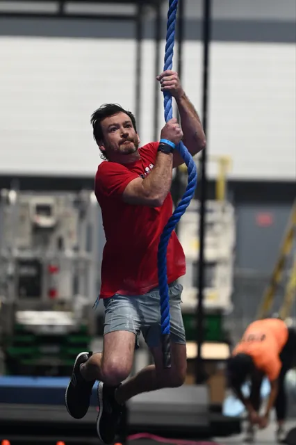 David Kiser swinging on a blue rope