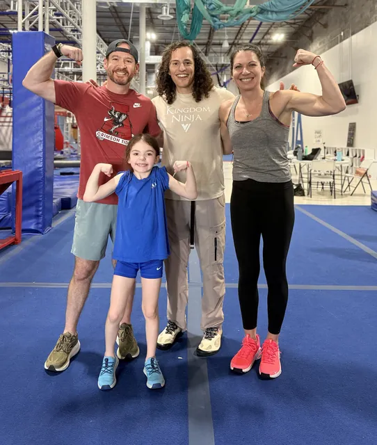 David, Elliot and Ashley Kiser flexing with Daniel Gil in a Kingdom Ninja shirt