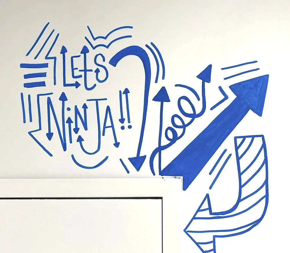 A Let's Ninja mural on the gym wall