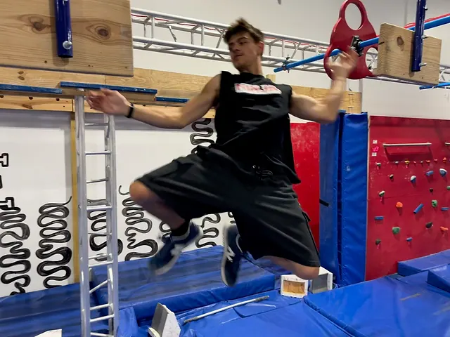 Coach Aiden Burley swinging off a spinning lache wheel