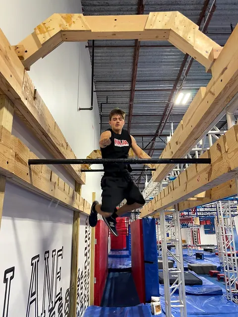 Coach Aiden Burley swinging through the bar lache lane