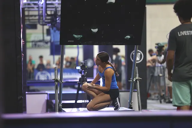 Coach Emily Fisher studying the next obstacle at a ninja competition